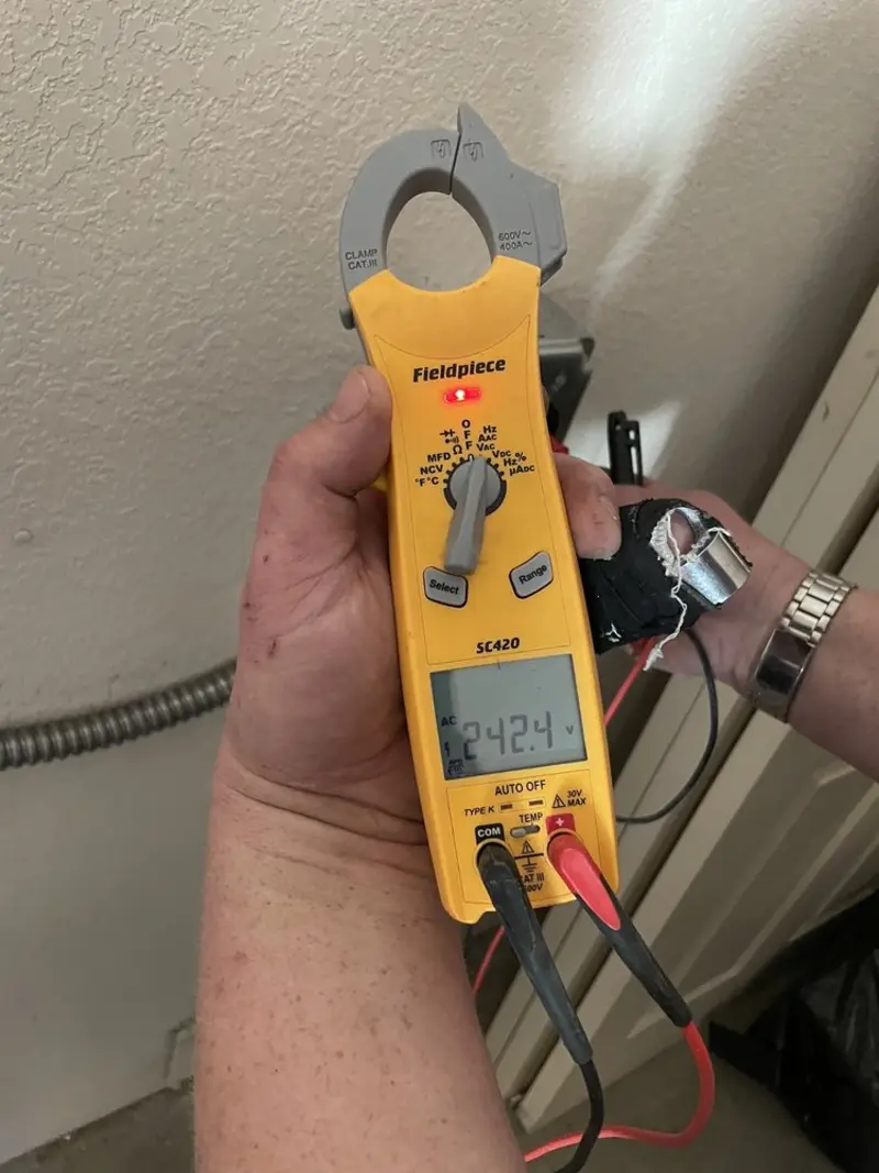 Voltage testing with clamp meter during Outlet Installation in Murillo